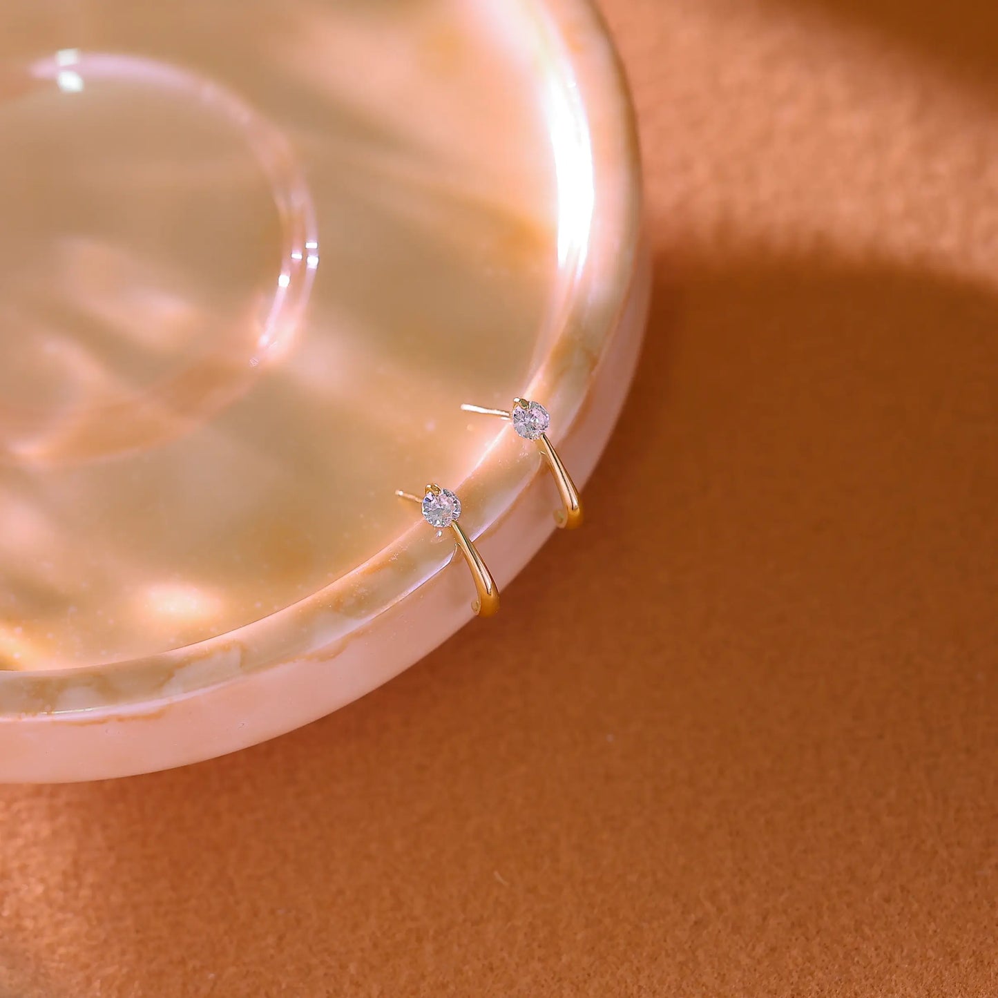 Side view showing the half-circle 'C' shape and the straight earring post.