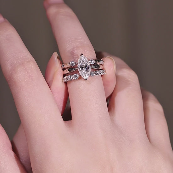 The three silver rings from the marquise moissanite stacking set displayed individually to show the 2ct solitaire, the 0.24ct open stacker, and the 0.48ct modern gap band.