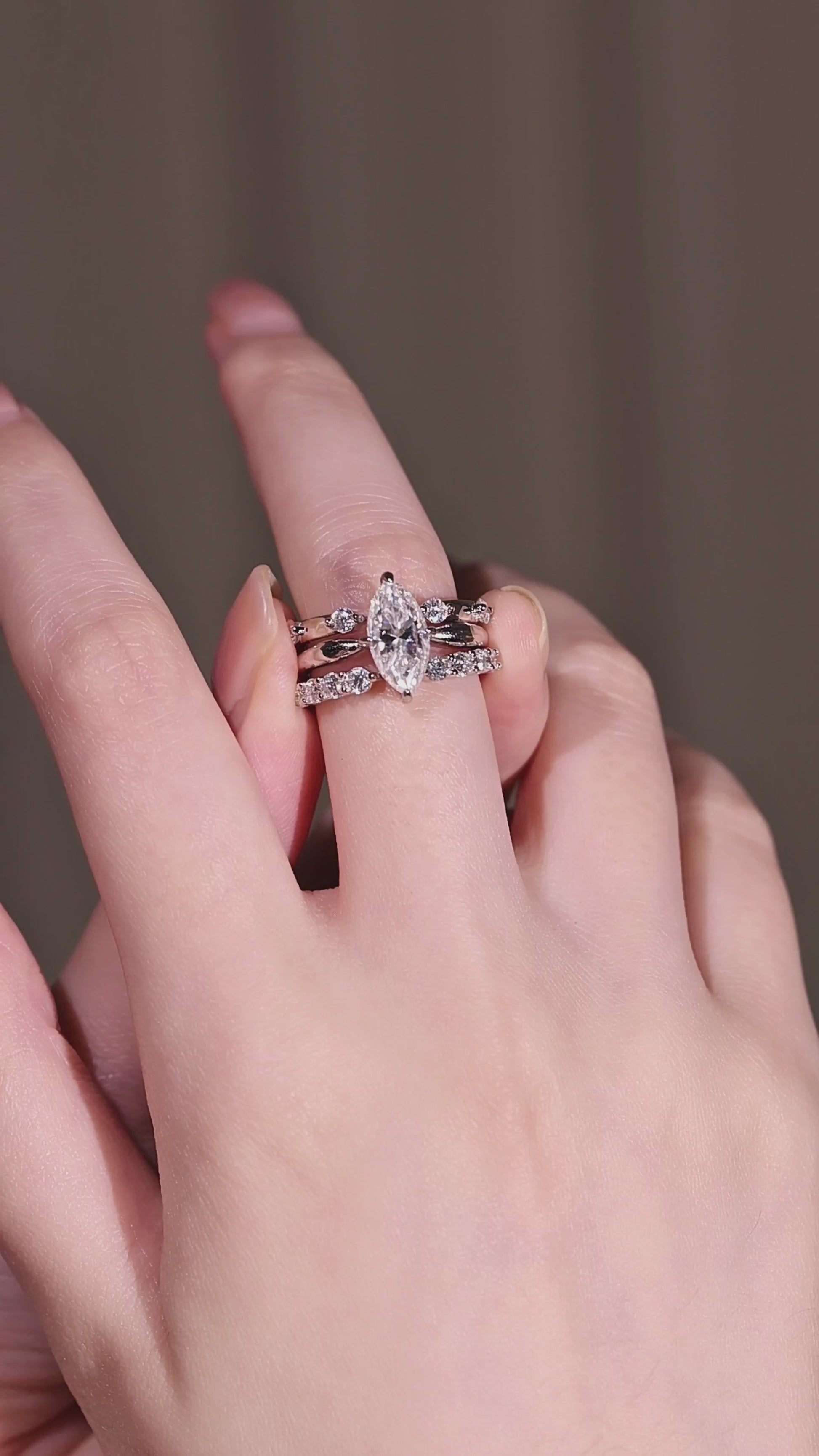 The three silver rings from the marquise moissanite stacking set displayed individually to show the 2ct solitaire, the 0.24ct open stacker, and the 0.48ct modern gap band.