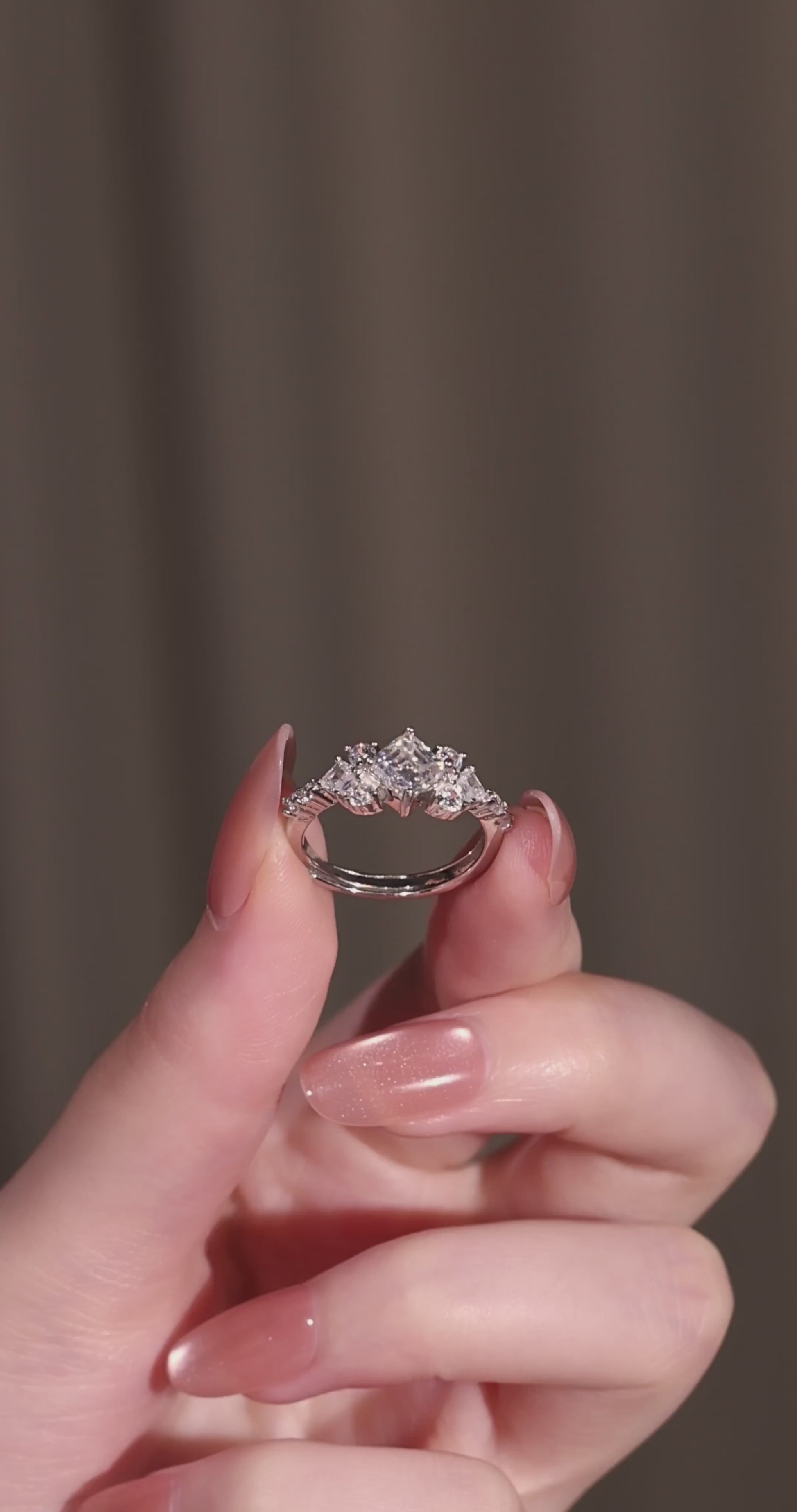 The geometric 1-carat square cut ring displayed elegantly next to its signature luxury gift box and protective microfibre pouch.